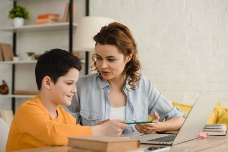 Image of a mother helping her son in studies